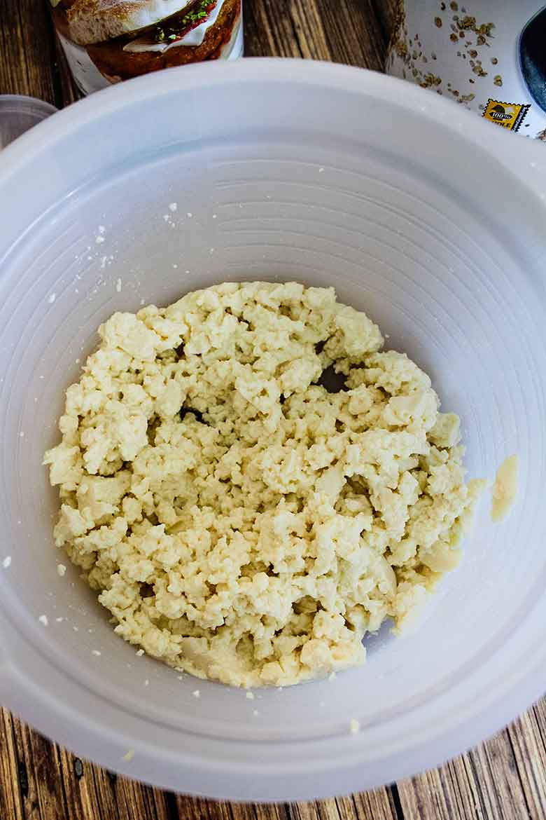 Soft mashed tofu in a mixing bowl.