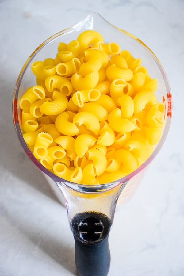 uncooked pasta in a measuring cup.