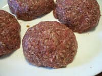 burgers filled with stuffing before grilling