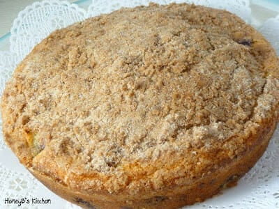 Whole Blueberry Crumb Cake on a white plate.