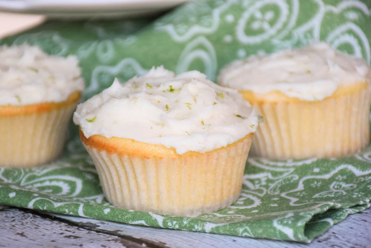 3 cupcakes on a green and white napkin