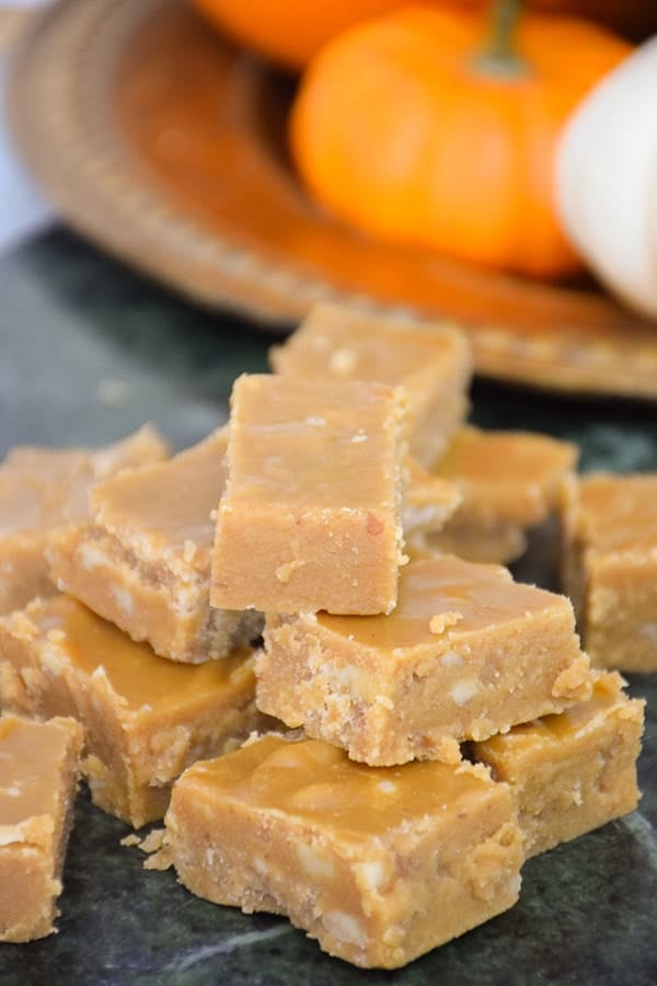 A stack of brown sugar fudge on a marble b oard.