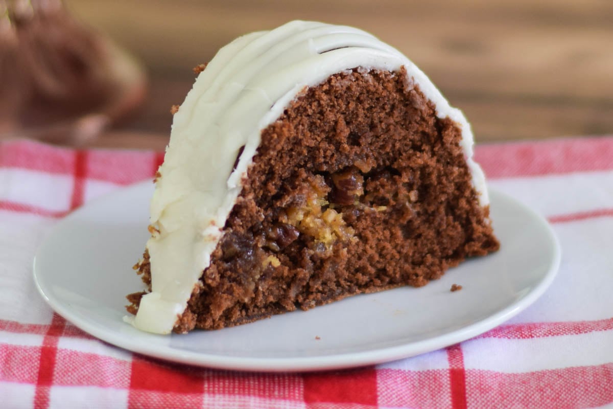 One slice of German Chocolate Bundt Cake on a white plate.