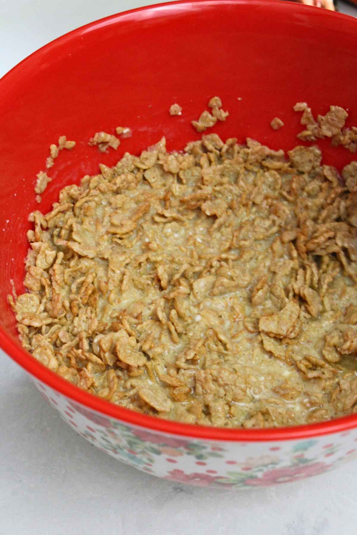 A red bowl with soaked cereal.