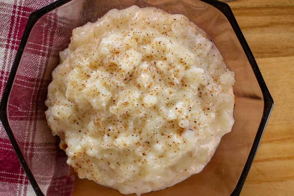 Old Fashioned Baked Rice Pudding in a vintage burgundy glass bowl