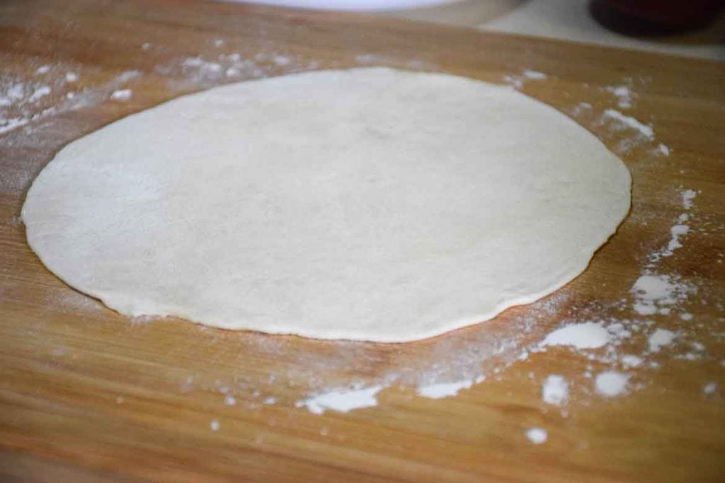 tortilla rolled out to size on floured board