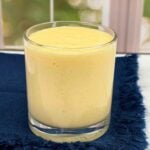 One glass filled with Mango Lassi.