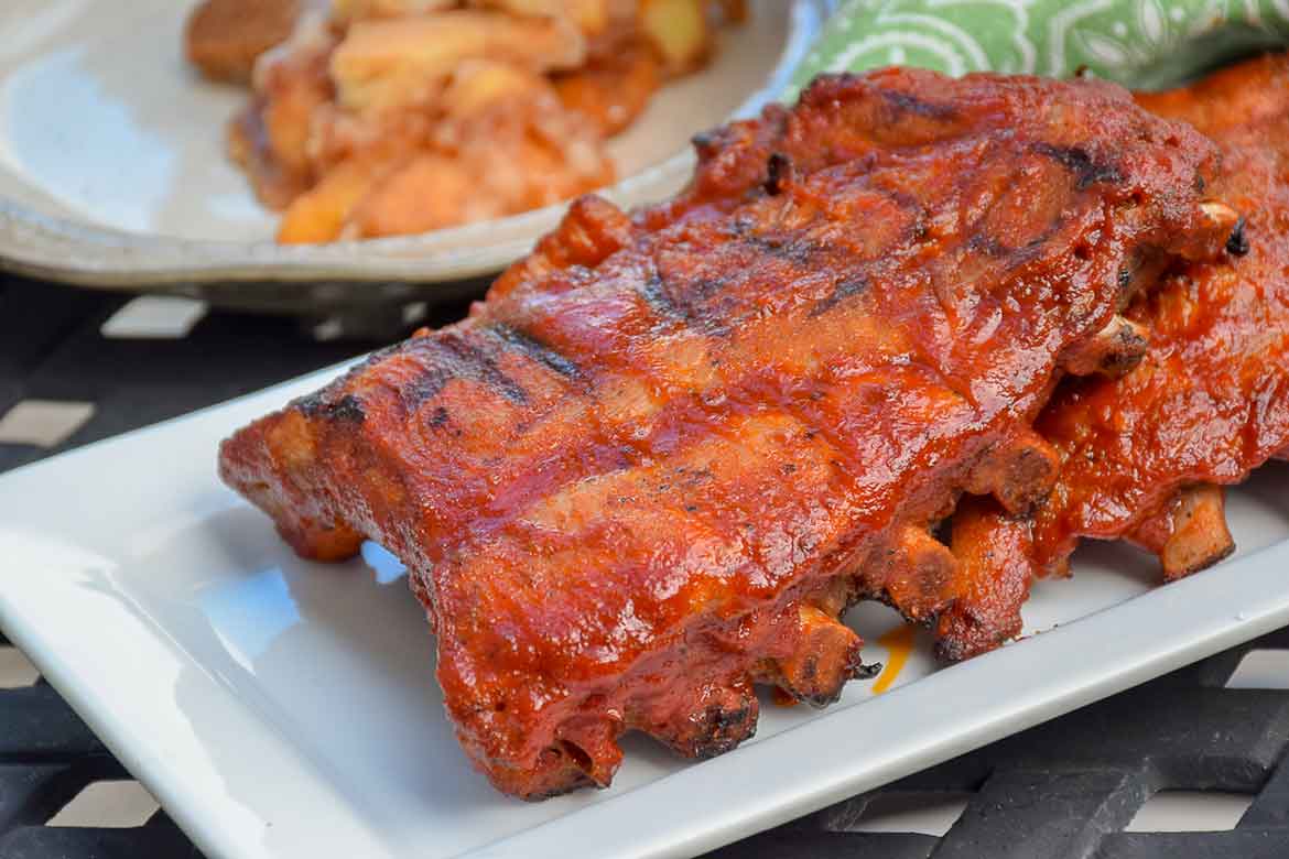 Stove-Top Baby Back Ribs after they have been grilled with barbecue sauce on a serving platter.