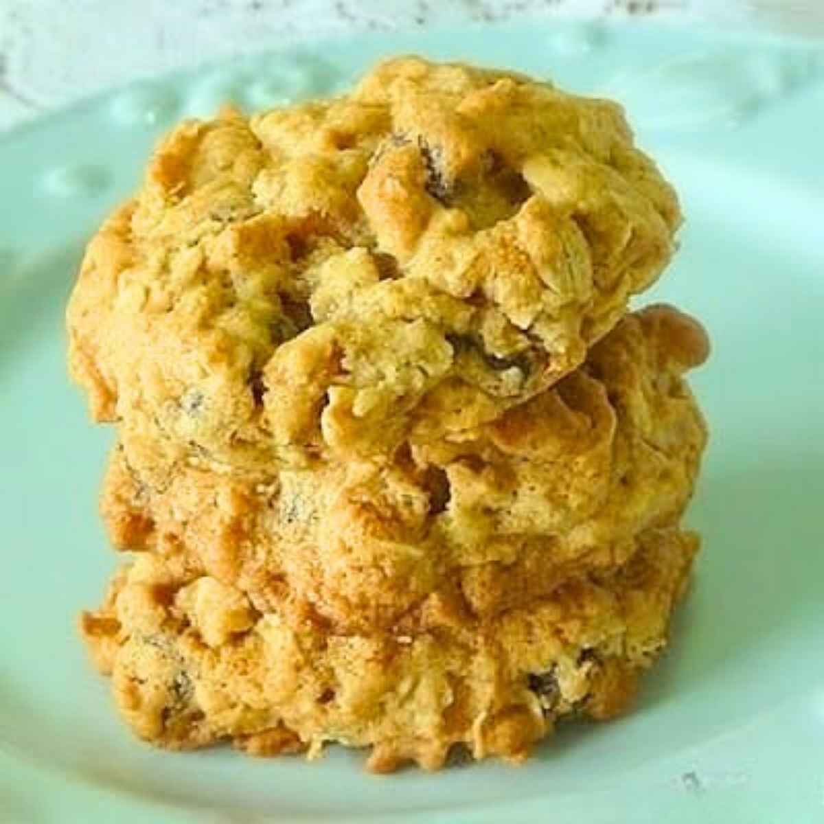 Three cookies stacked on one another on a pale blue plate.