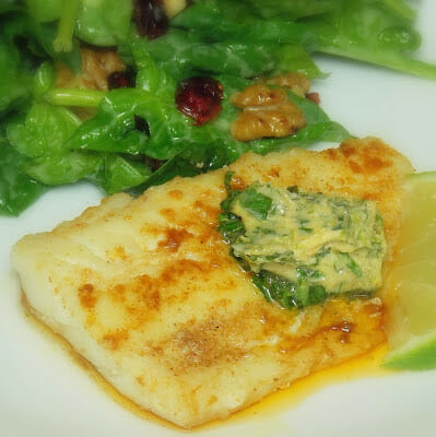 Cooked skillet cod topped with cilantro lime butter.