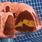 A banana marble bundt cake on a cake platter.