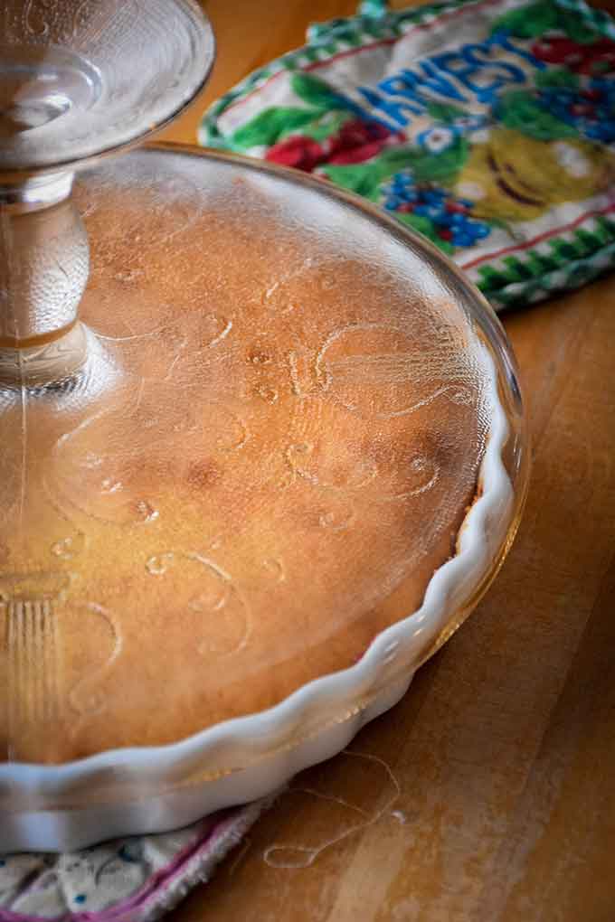 Plate on top of baked cake ready to flip over.