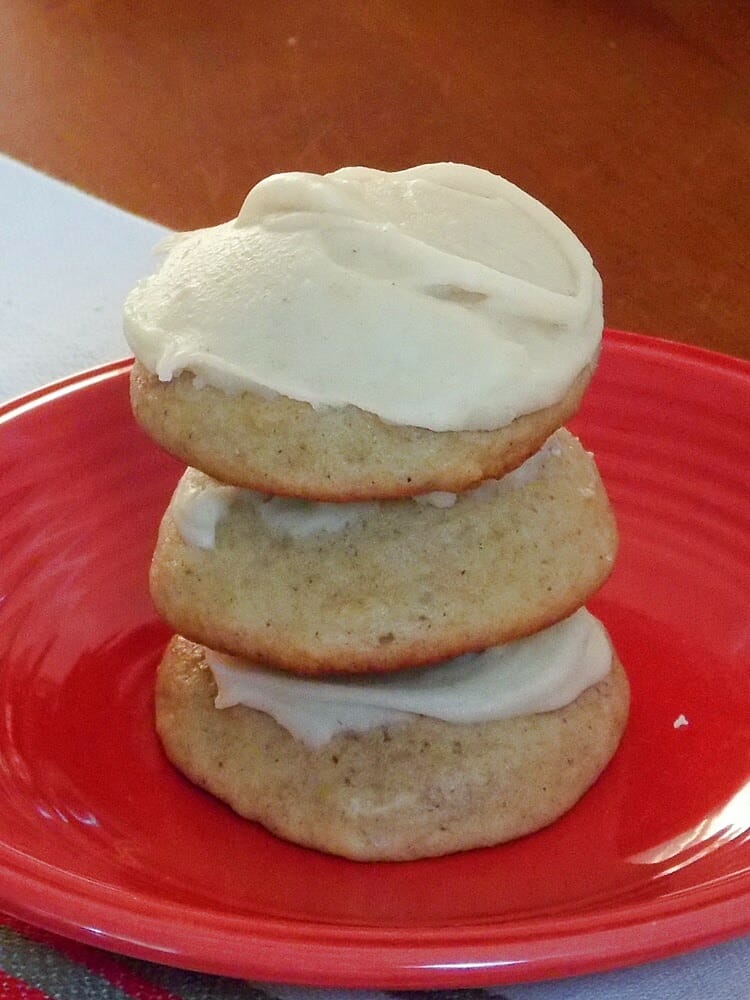 a stack of 3 iced and baked cookies on a plater