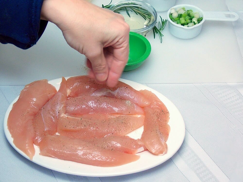 Seasoning chicken tenders with salt