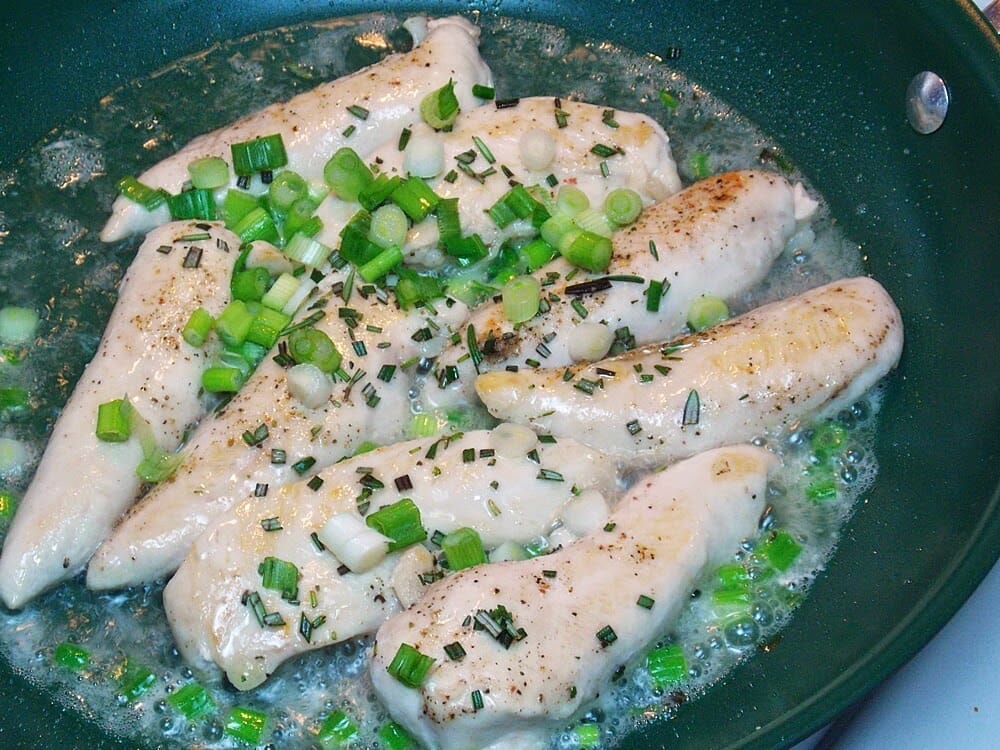 chicken tenders cooking in a skillet