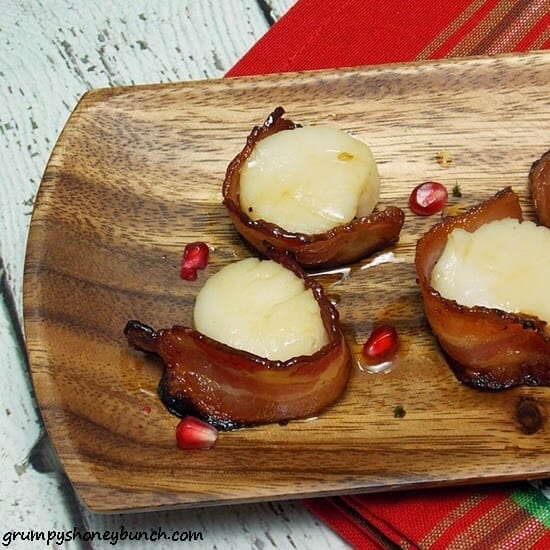 Bourbon Maple Bacon Wrapped Scallops on a wooden serving tray.