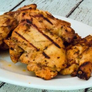 Beer Grilled Chipotle Chicken thighs with visible grill marks served on a white plate.