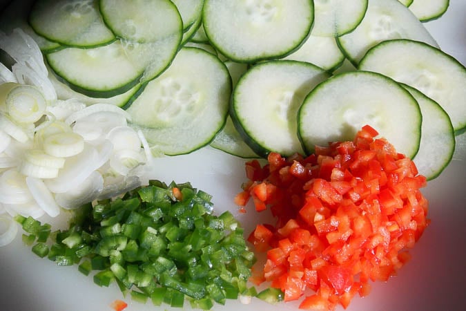 Thinly sliced cucumber, diced red and green peppers and sliced scallions.