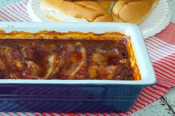 Bourbon Bacon Baked Beans in a blue casserole dish