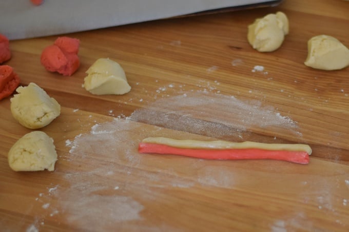 colored rolled cookie dough ropes lined up together