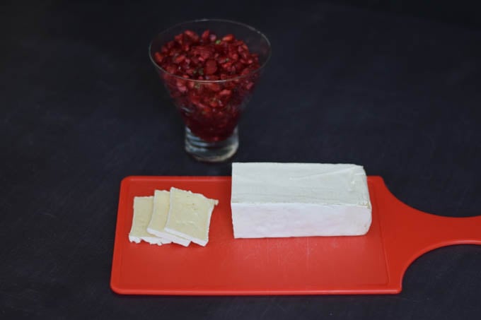 brie slices with cranberry relish in the background