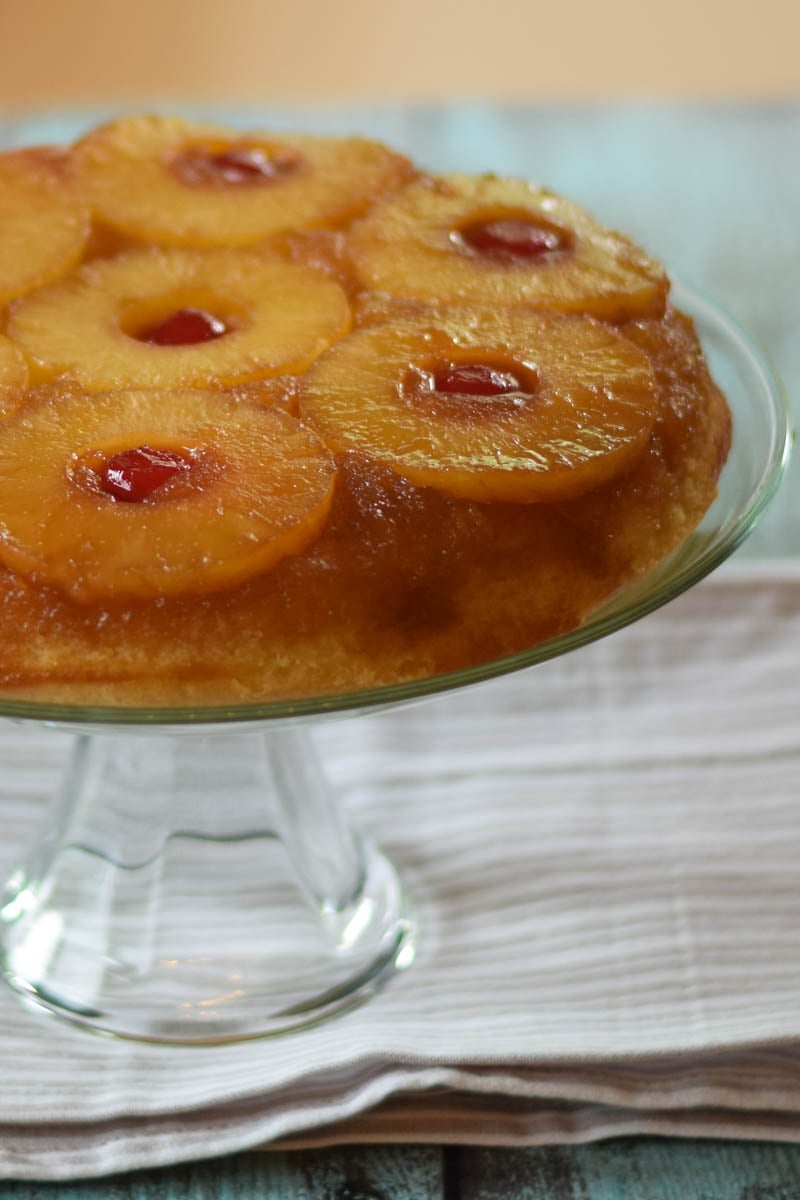 Whole cake on a glass cake stand.