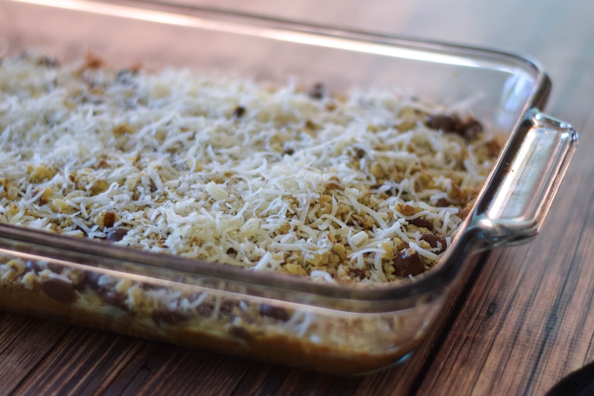 Baking dish with layers of dessert bar ingredients.