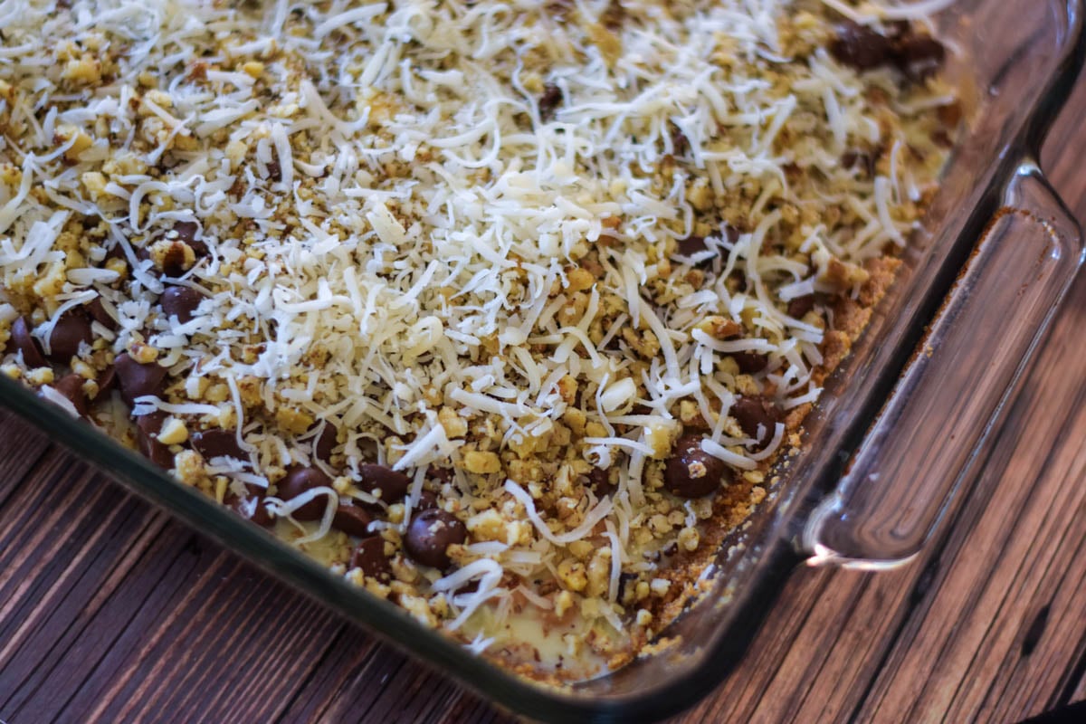 Overhead image of unbaked layer bars in baking dish.