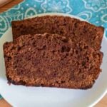 Two slices of chocolate zucchini bread on a white plate.