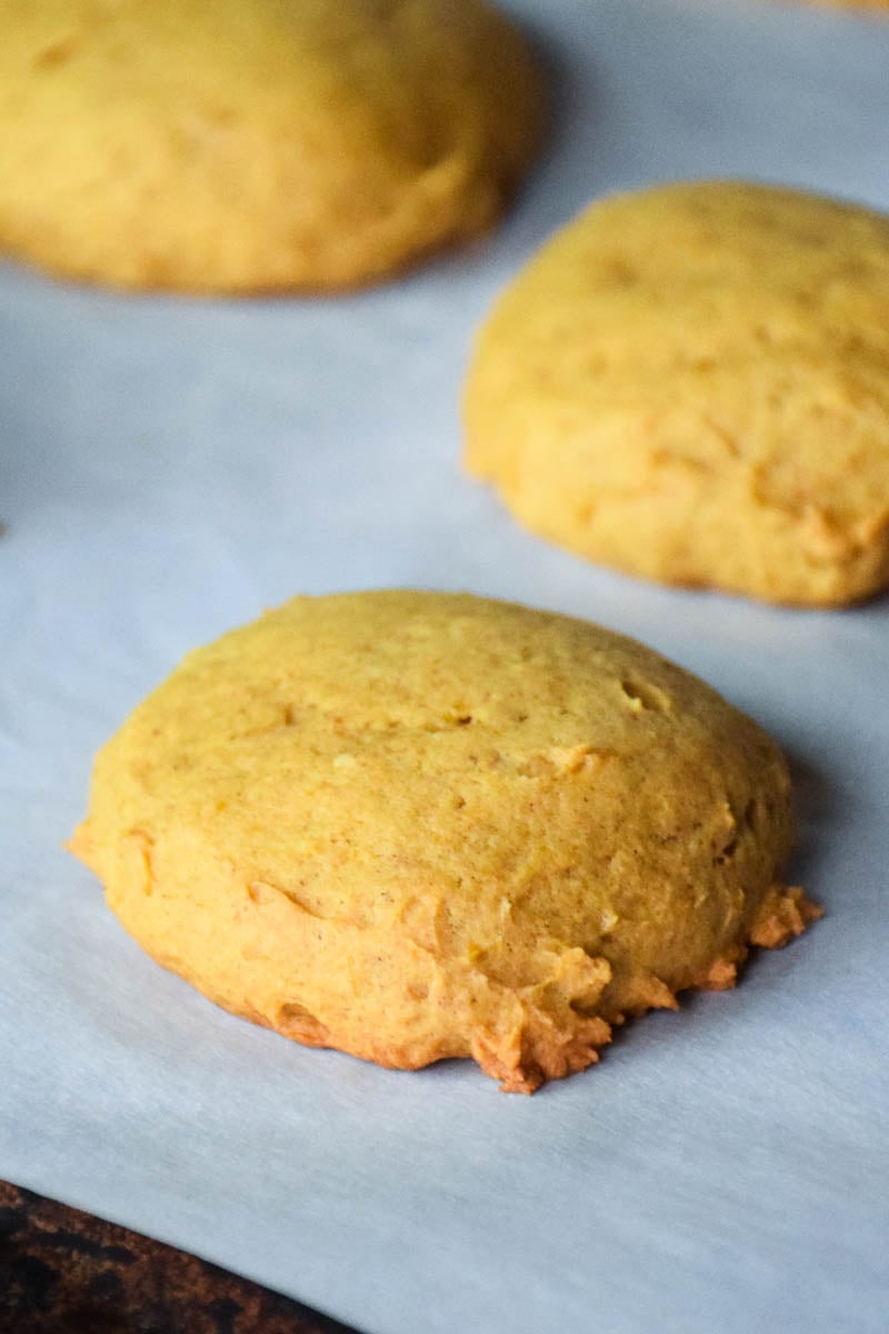 Baked cookies on parchment lined baking sheet.