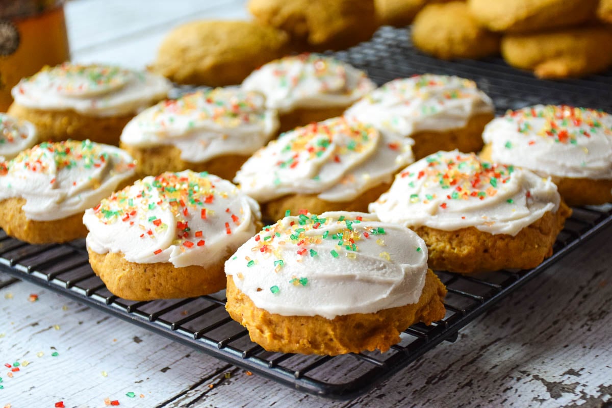 Baked and frosted cookies on cooling rack.