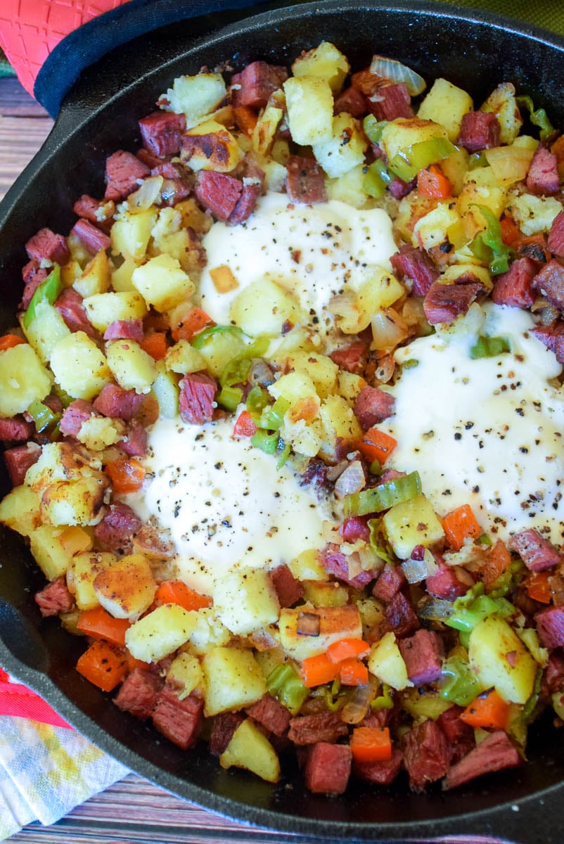 Homemade Corned Beef Hash and  Eggs in cast iron skillet.