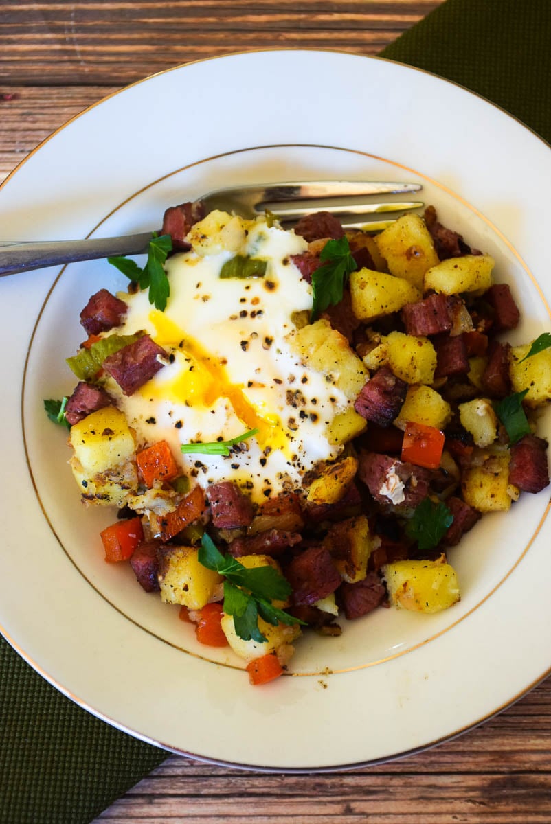 Homemade Corned Beef Hash topped with a runny egg.