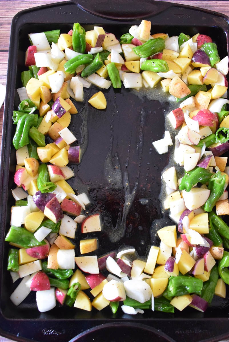 Veggies on a sheet pan with a cleared spot in the center of the pan.