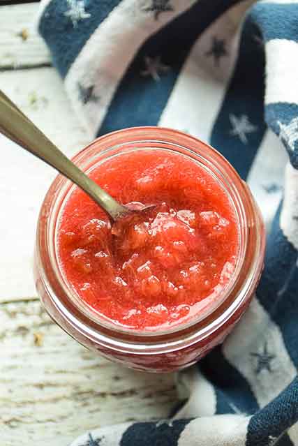 Mom's Rhubarb Sauce in a mason jar with a spoon in the sauce