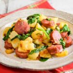 Upclose image of a plate full of kielbasa potato skillet dinner.