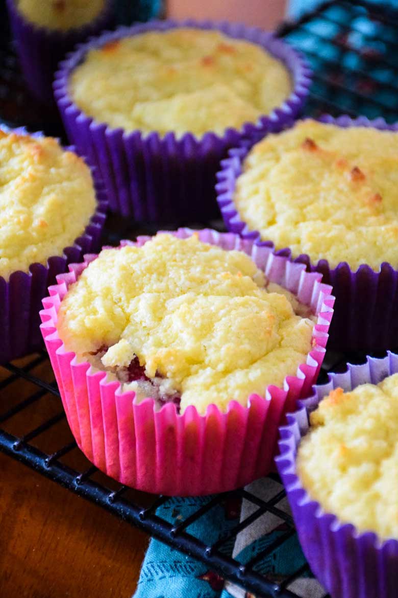 Keto Raspberry Muffins on a cooling rack.