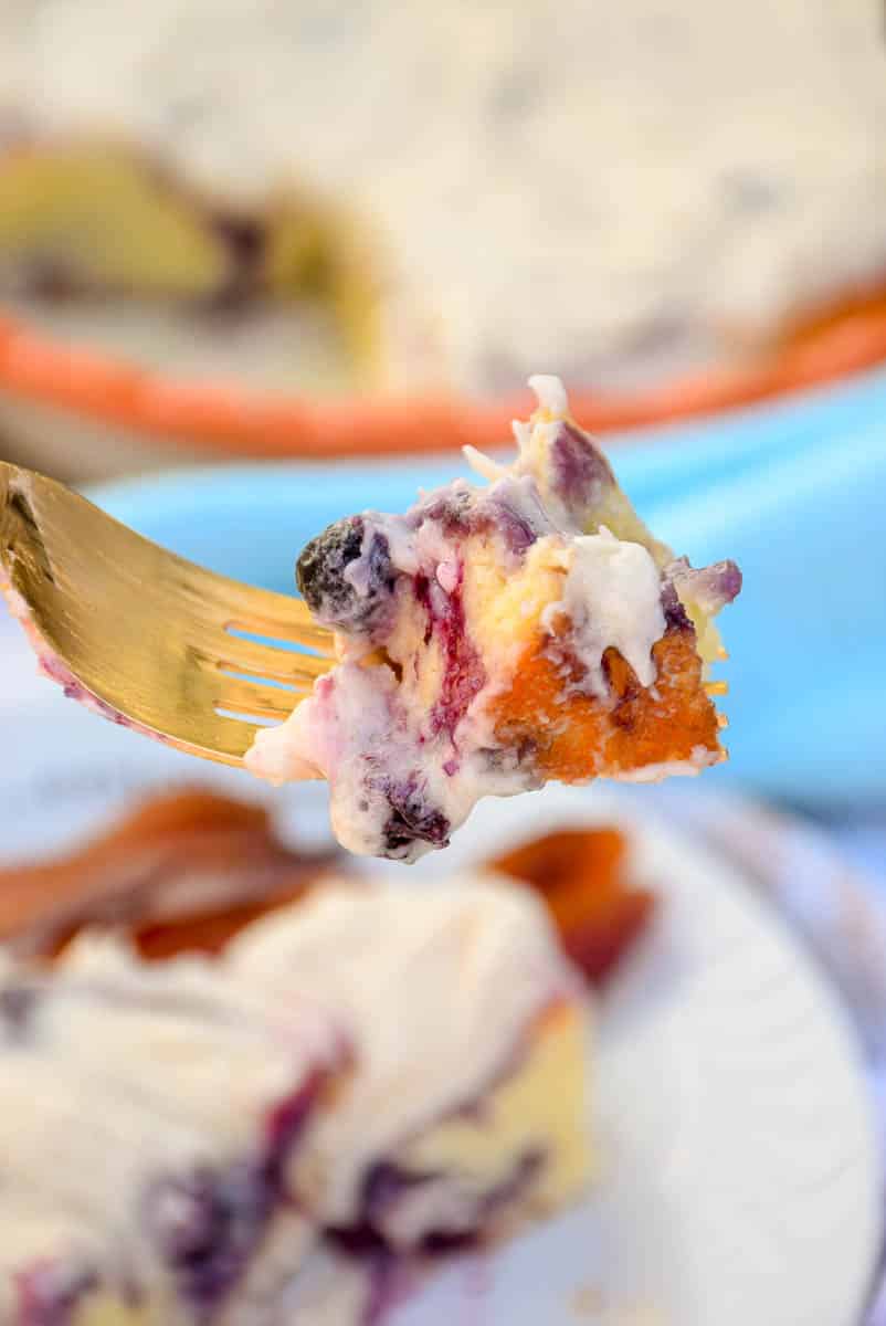 A cut piece of sweet roll on a fork.