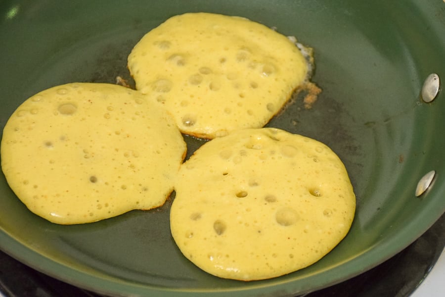 silver dollar sized keto pancakes in the skillet