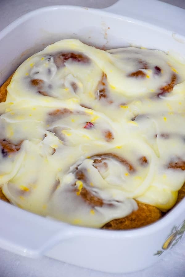 Frosted sweet rolls in baking dish.