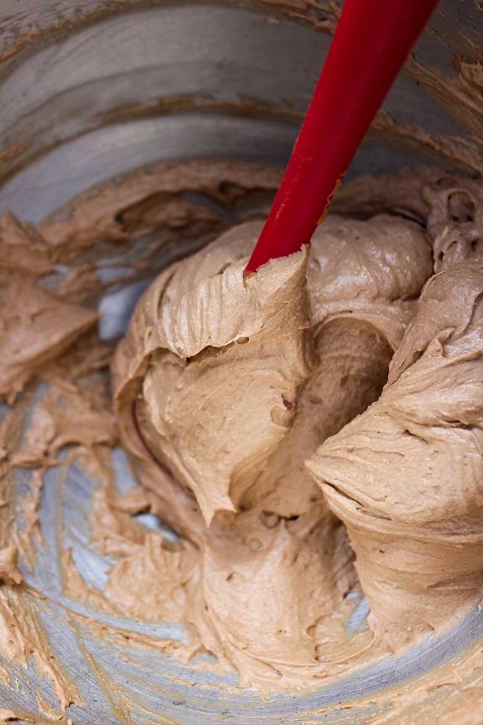 Shot of folding the heavy whipping cream into the batter with rubber spatula