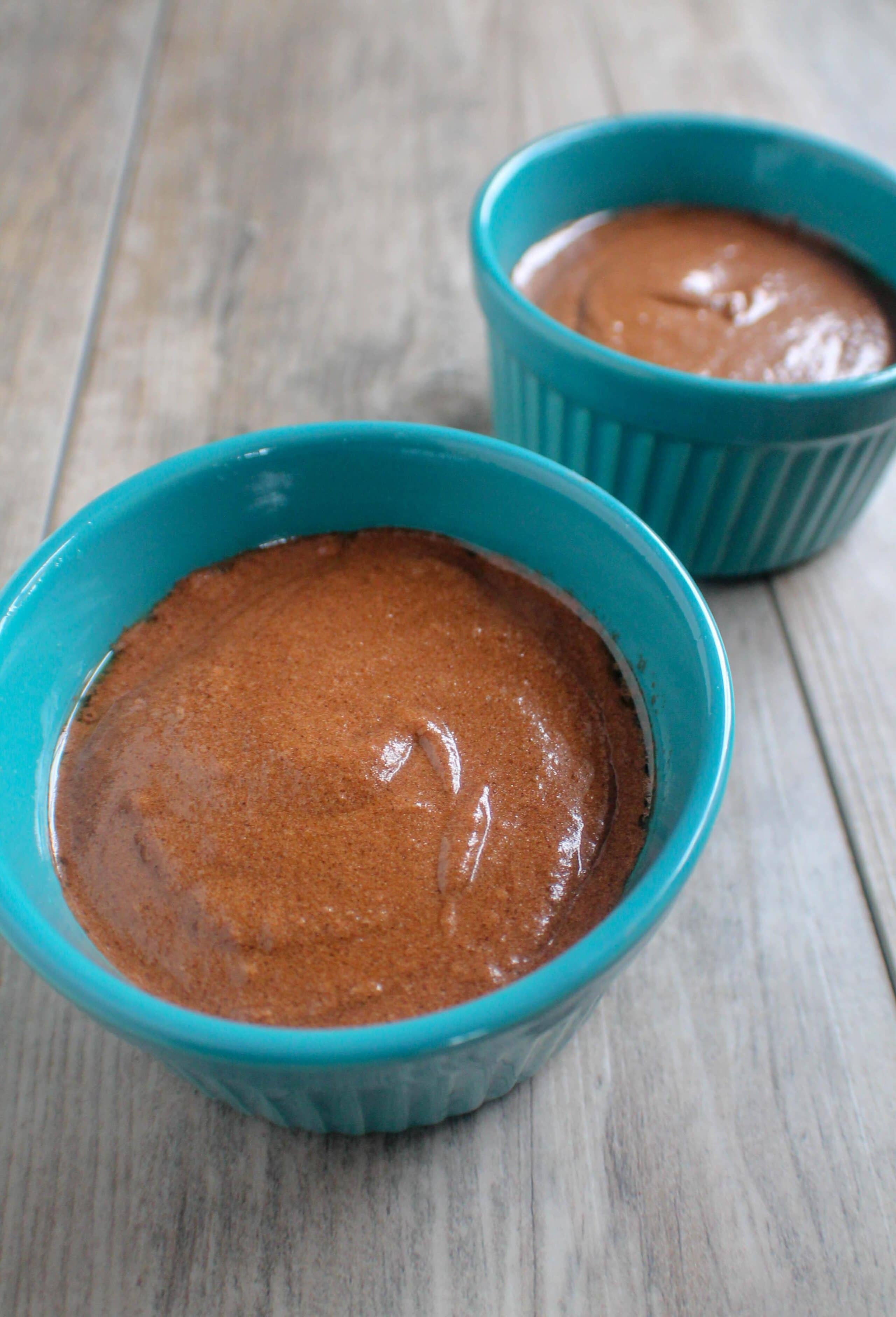 Uncooked cake batter in blue ramekins.