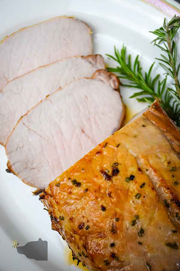 Overhead image of air fryer pork loin with maple glaze with slices cut from the roast.