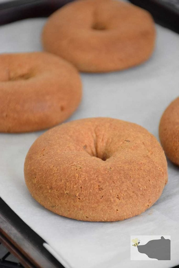 Baked Keto Rye Bagels on baking sheet with parchment paper