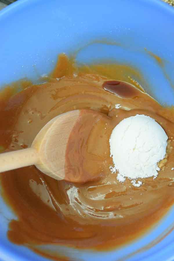 swerve sweetener in blug mixing bowl on top of peanut butter mixture