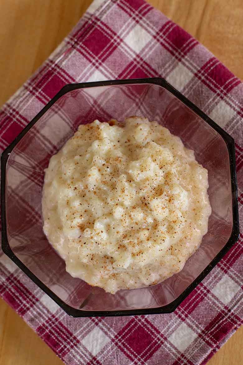 Old Fashioned Baked Rice Pudding in a vintage burgundy glass bowl.