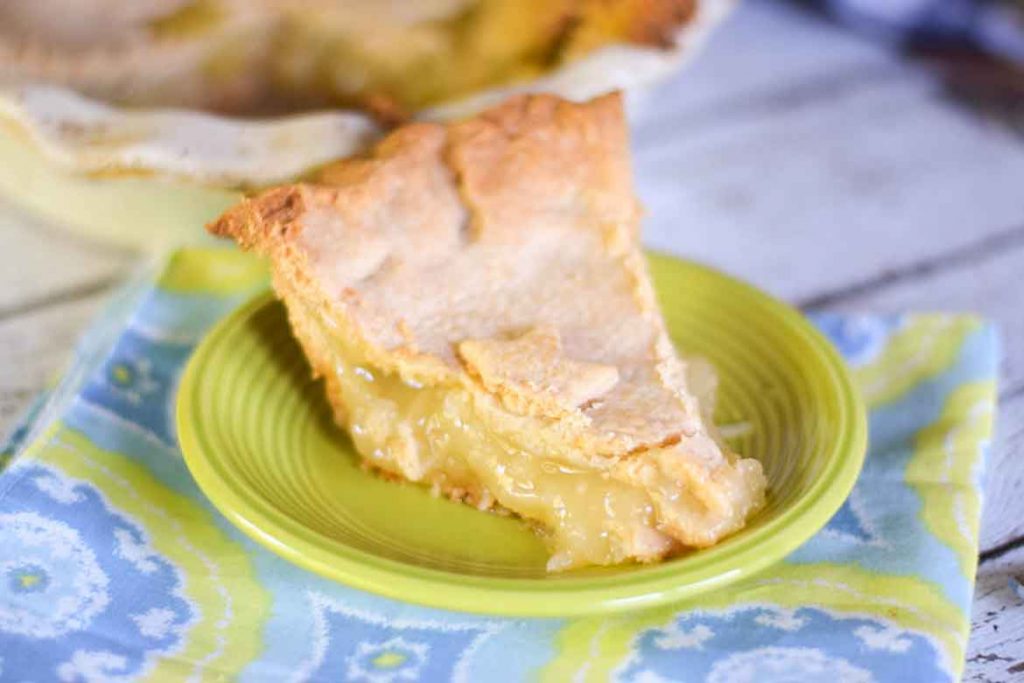 A slice of Pineapple Pie on a Neon Green Plate with yellow, blue, and white napkin