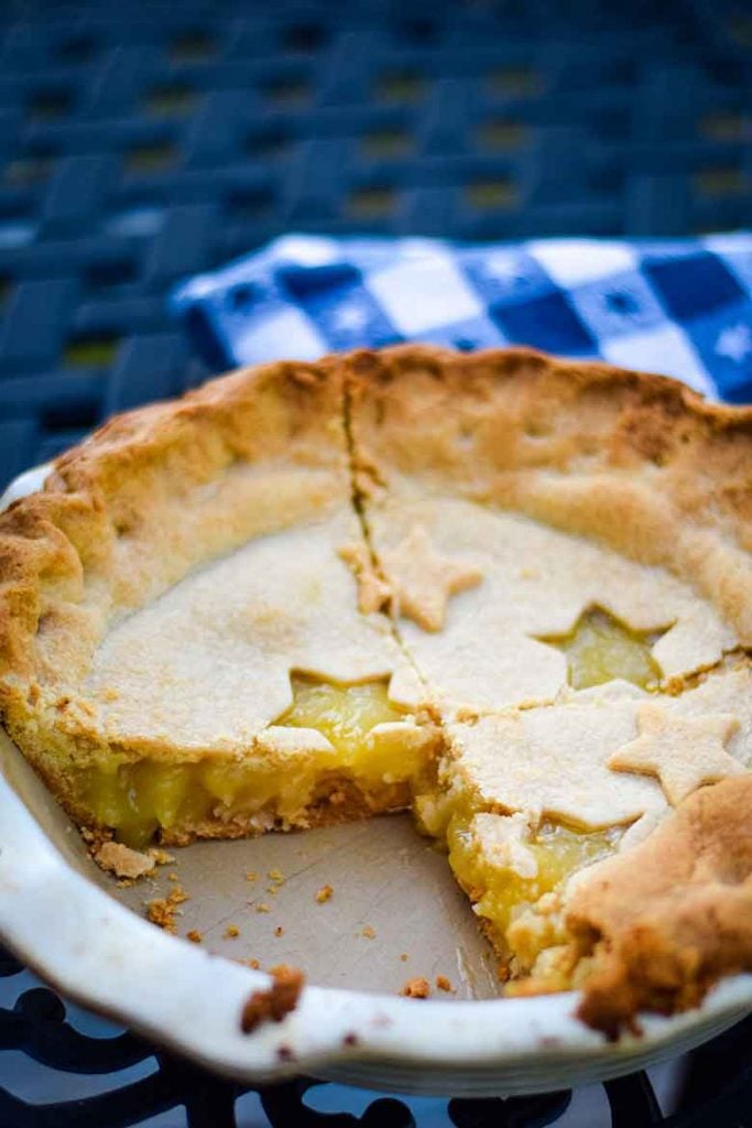 Fully baked Pineapple Pie with two slices cut out, overhead view