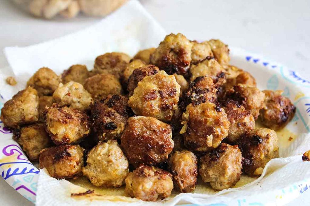 Fried Veal Meatballs draining on paper towel lined plate