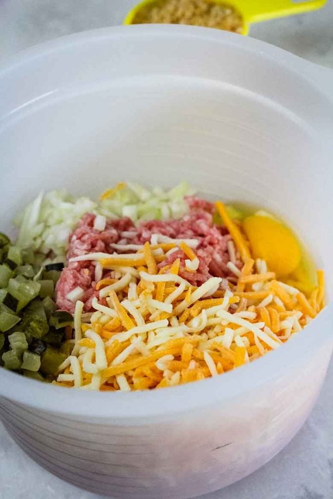 A mixing bowl with meatloaf ingredients